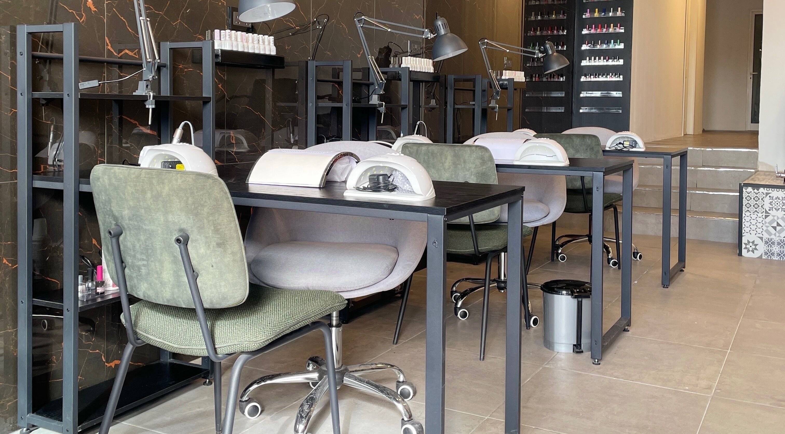 Modern nail salon setup at Diva Beauty Lounge, Tas-sliema, MT, showcasing manicure stations.