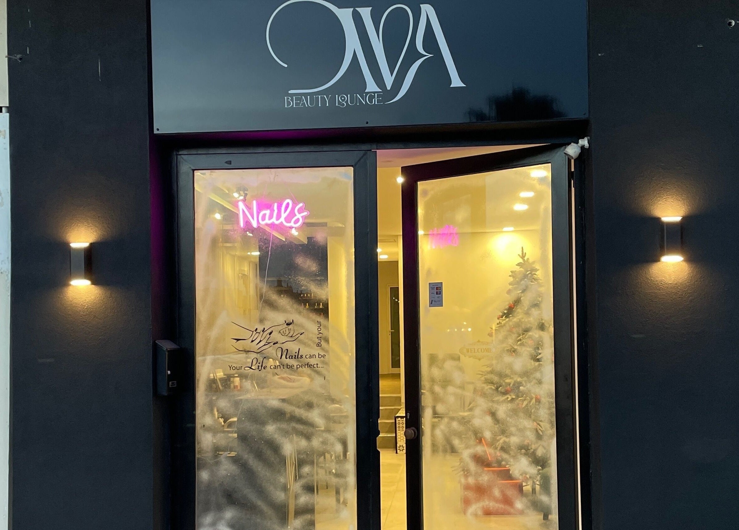 Exterior of Diva Beauty Lounge in Tas-sliema, MT with inviting lights and festive decor.