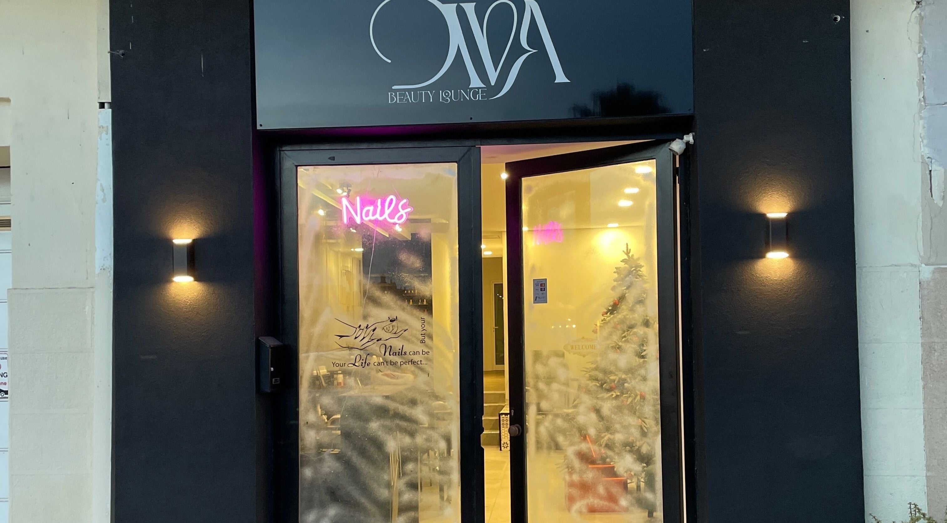 Exterior of Diva Beauty Lounge in Tas-sliema, MT with inviting lights and festive decor.