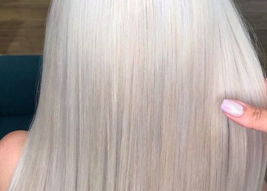 Platinum blonde hair styled at Lily Hair Studio, Barcelona, Catalunya, ES, showcasing smooth, shiny finish.