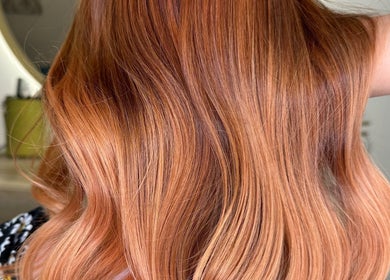Vibrant copper hair styling at Lily Hair Studio in Barcelona, Catalunya, ES showcasing wavy luxurious locks.