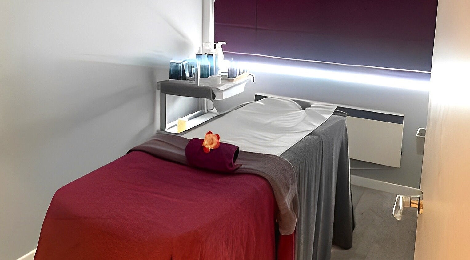Massage room at Harborne Spa & Clinic in Birmingham, England. Relaxing ambiance with cozy bed and serene lighting.