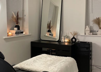 Cozy spa room at Nova Luxe, Pudsey, England, GB, featuring a plush treatment bed and chic decor.