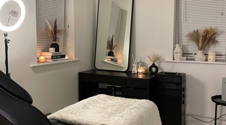 Cozy spa room at Nova Luxe, Pudsey, England, GB, featuring a plush treatment bed and chic decor.