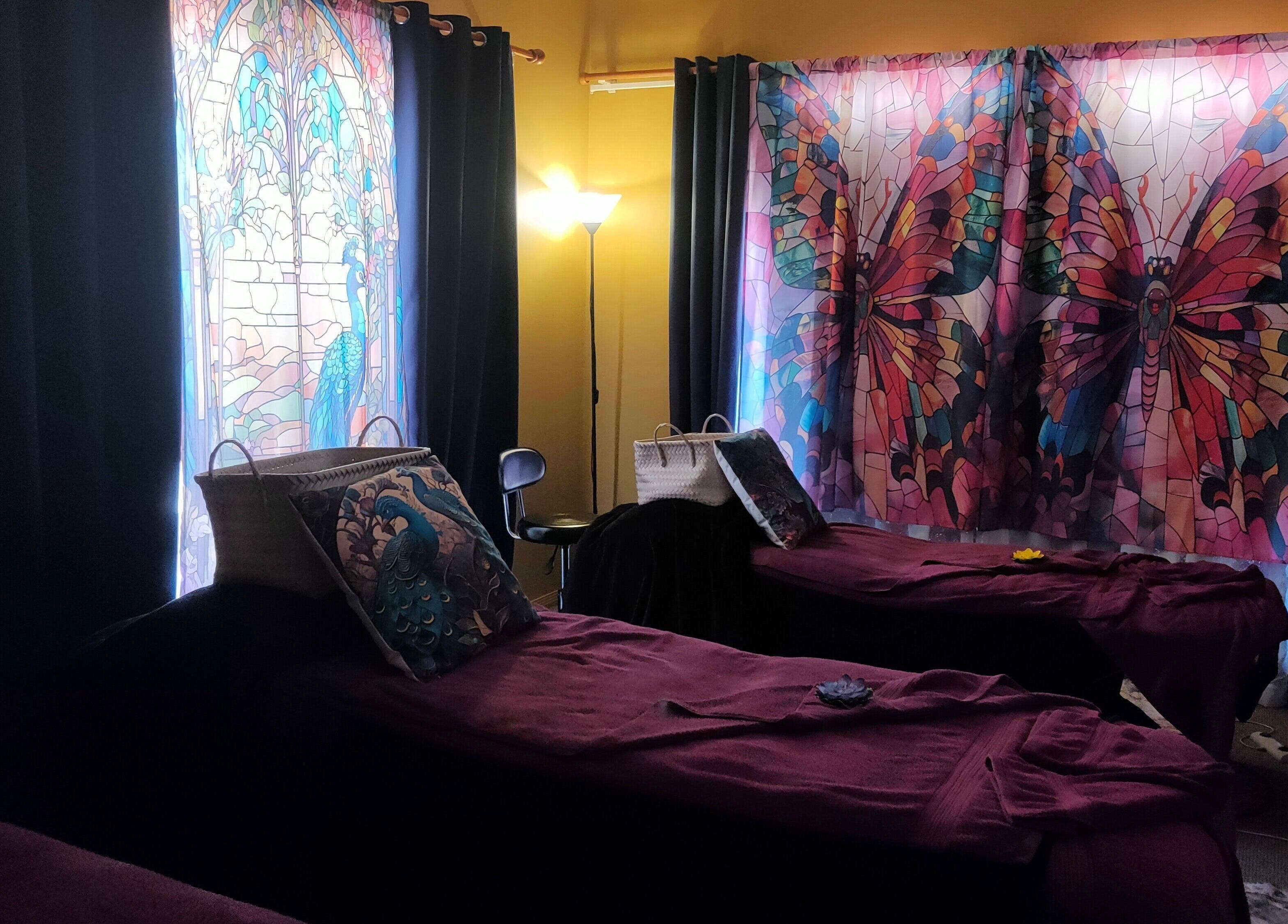 Relaxing massage room at Blissage Day Spa Sanctuary, Tamborine Mountain, Queensland, AU with tranquil stained-glass decor.