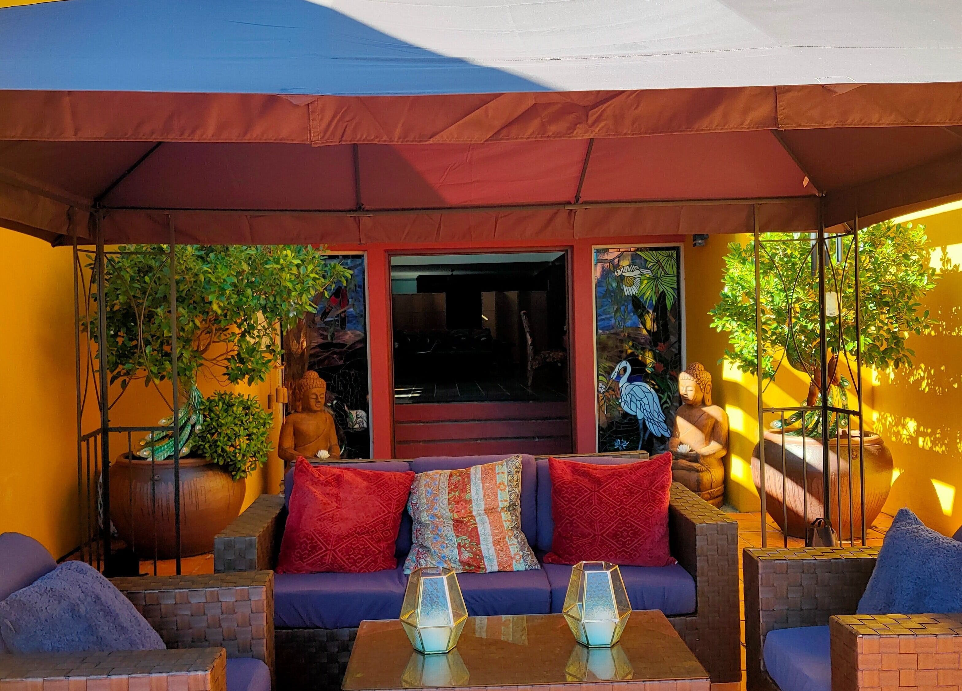 Inviting lounge area at Blissage Day Spa Sanctuary, Tamborine Mountain, Queensland, AU with colorful cushions.