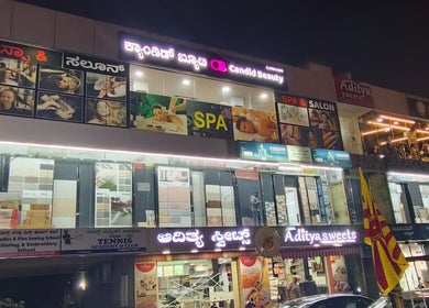 Exterior of Candid Beauty Salon and Spa in Bengaluru, Karnataka, IN beautifully lit at night.