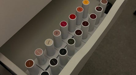 Assorted nail polish colors in open drawer at Krys Rosa Studio, Kingsteignton, England, GB.