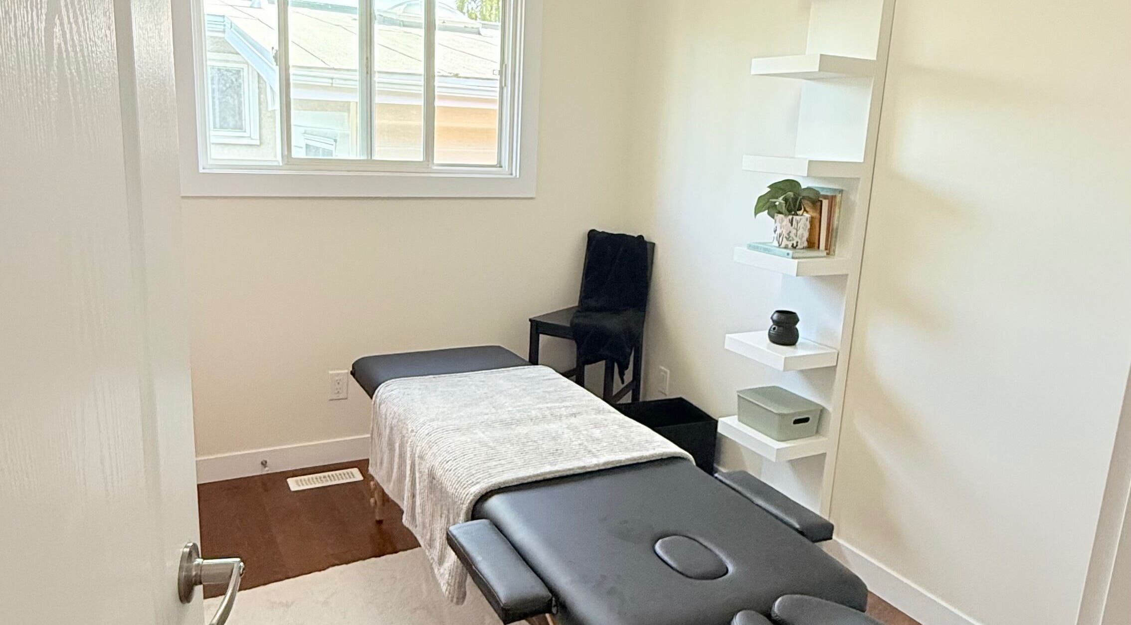 Relaxing massage room at Breath Ease Massage Studio, Edmonton, Alberta, CA with table and calming decor.