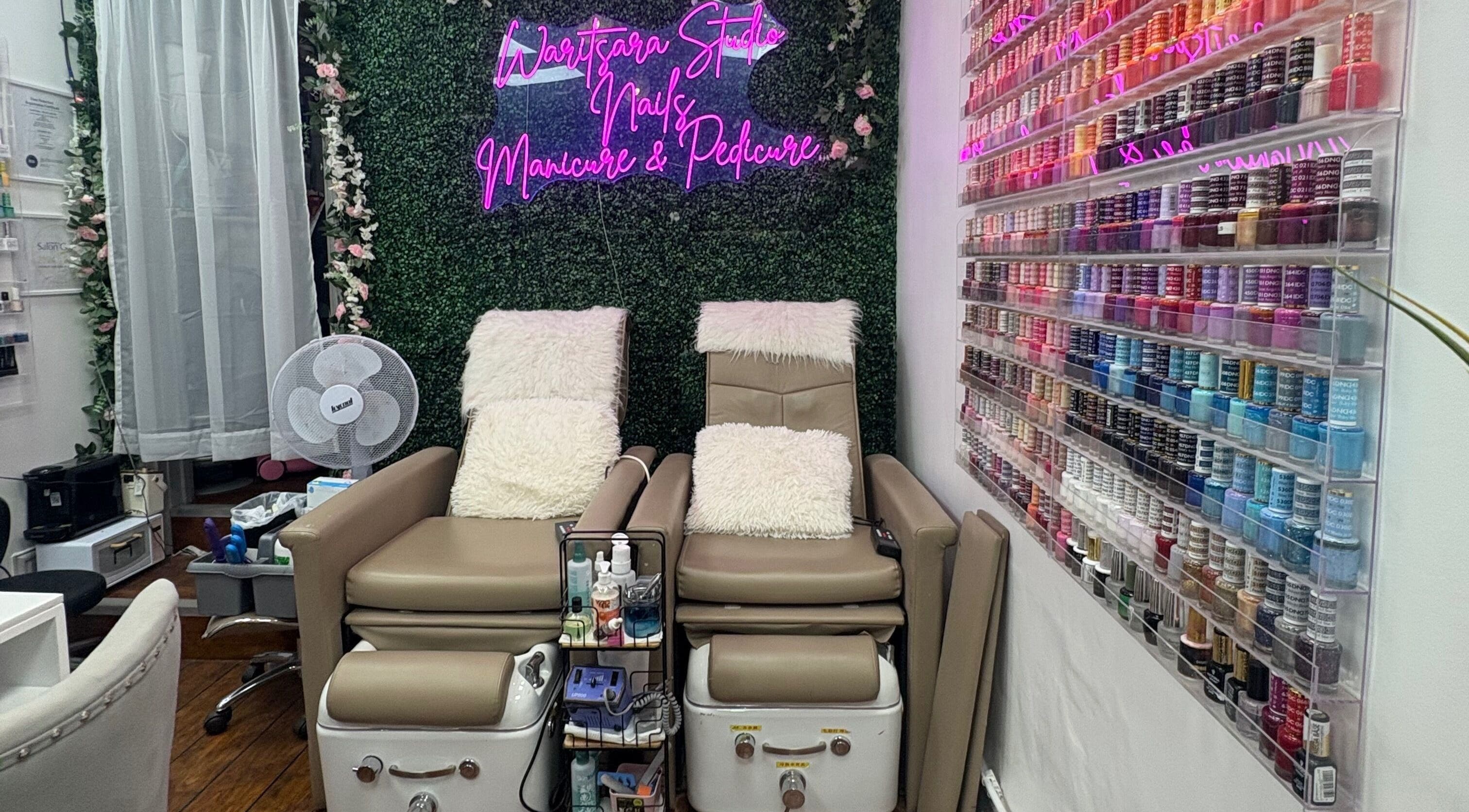 Luxurious nail spa chairs and vibrant polish display at Waritsara Studio Nails in Oundle, England, GB.