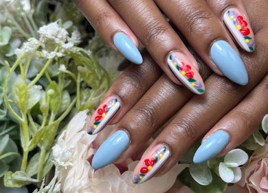 Elegant floral nail art at Waritsara Studio Nails in Oundle, England, GB, showcasing colorful flower designs.