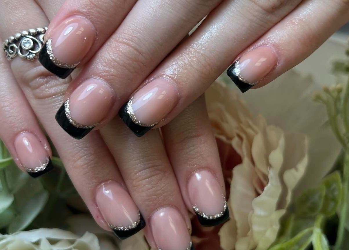 Elegant black French manicure at Waritsara Studio Nails in Oundle, England, GB, showcasing floral accents.