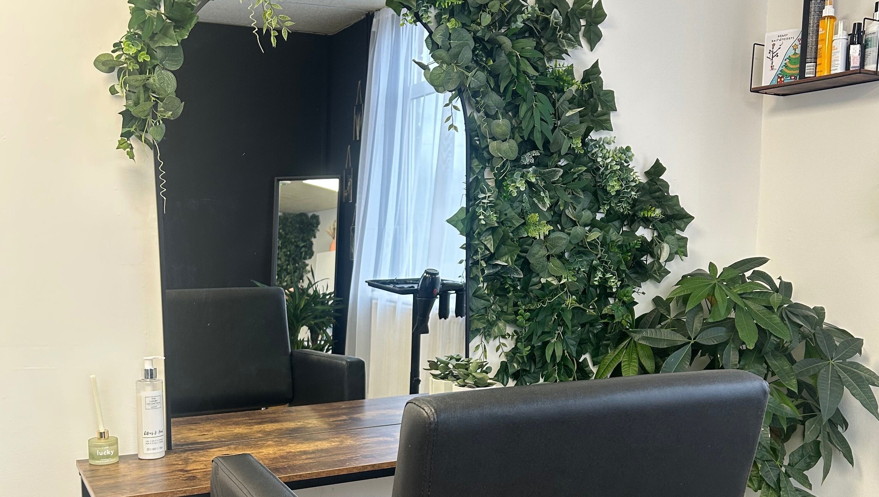 Lush green plants adorn a styling station at Stephanie Duval Hair at Eselle Collective, Bristol, England, GB.
