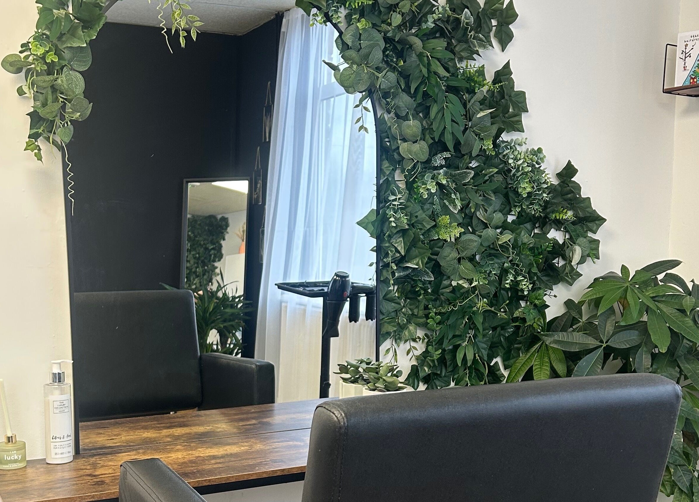 Lush green plants adorn a styling station at Stephanie Duval Hair at Eselle Collective, Bristol, England, GB.