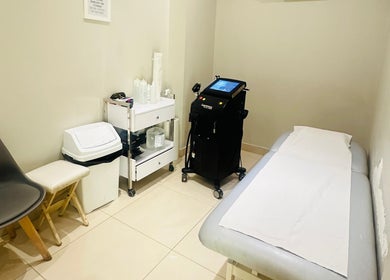 Modern treatment room at Camden beauty spa, London, England, GB with massage bed and equipment.