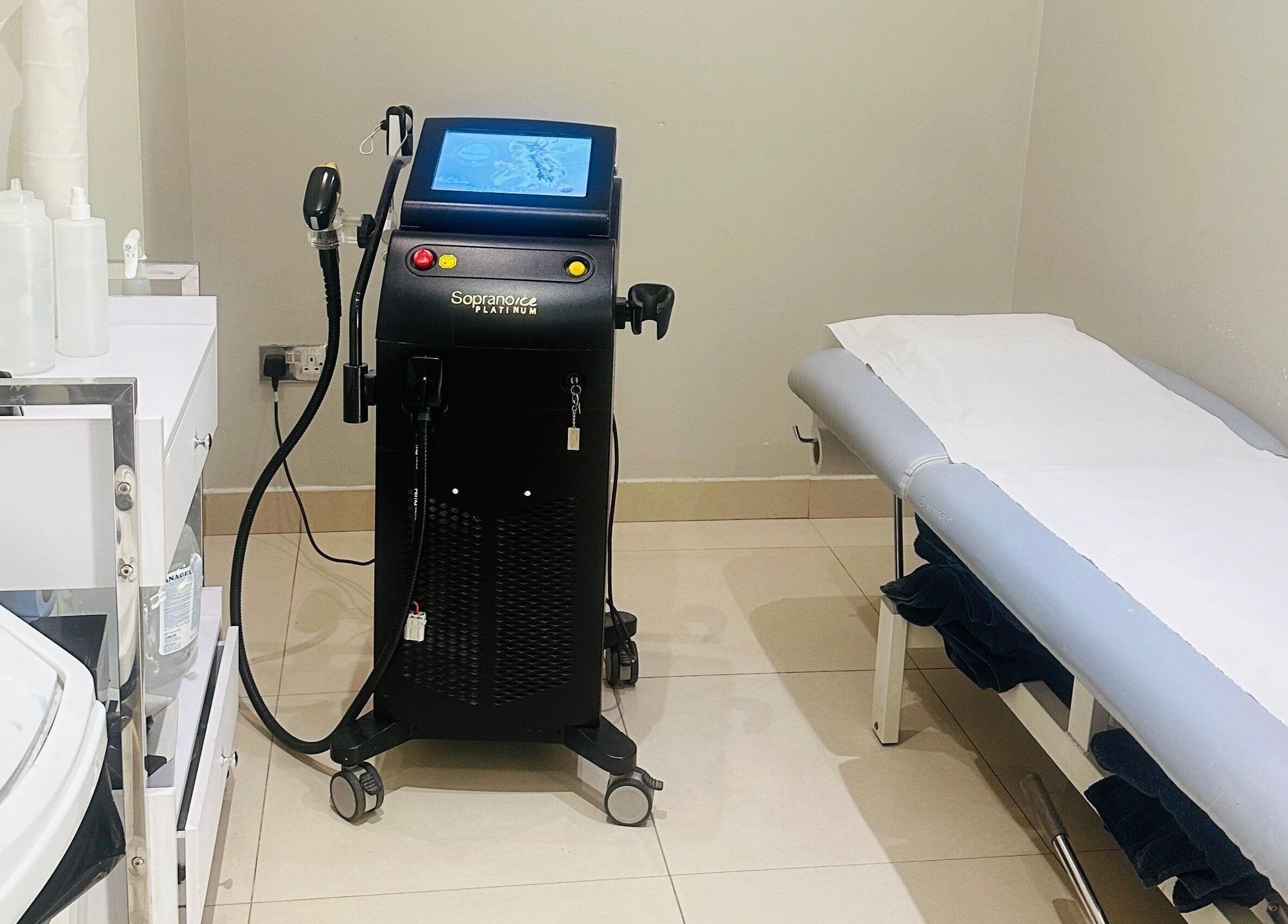 Modern treatment room at Camden beauty spa, London, England, GB, featuring advanced equipment and a comfortable bed.