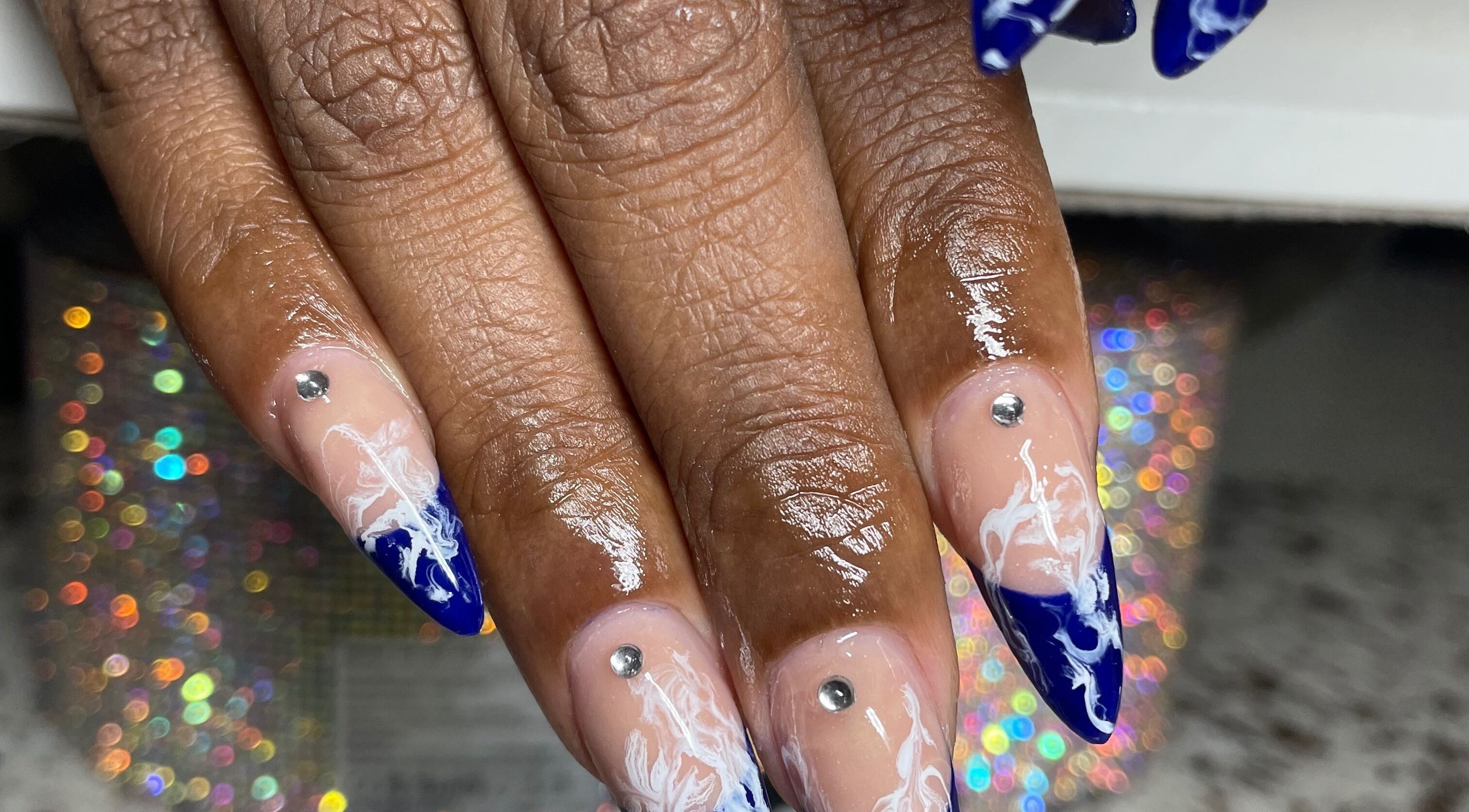 Elegant navy and white nail art with rhinestones at Nails On The Blvd, St. James, BB.