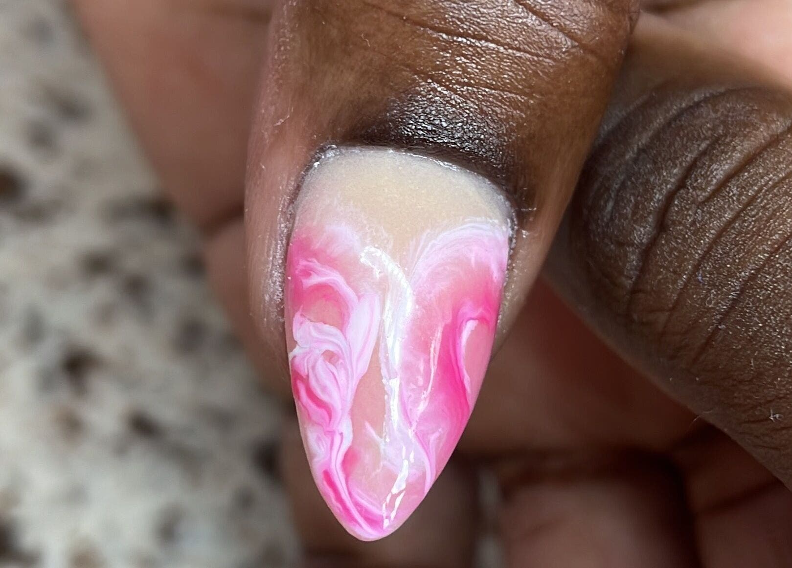 Close-up of a pink and white swirl nail design at Nails On The Blvd, St. James, BB.
