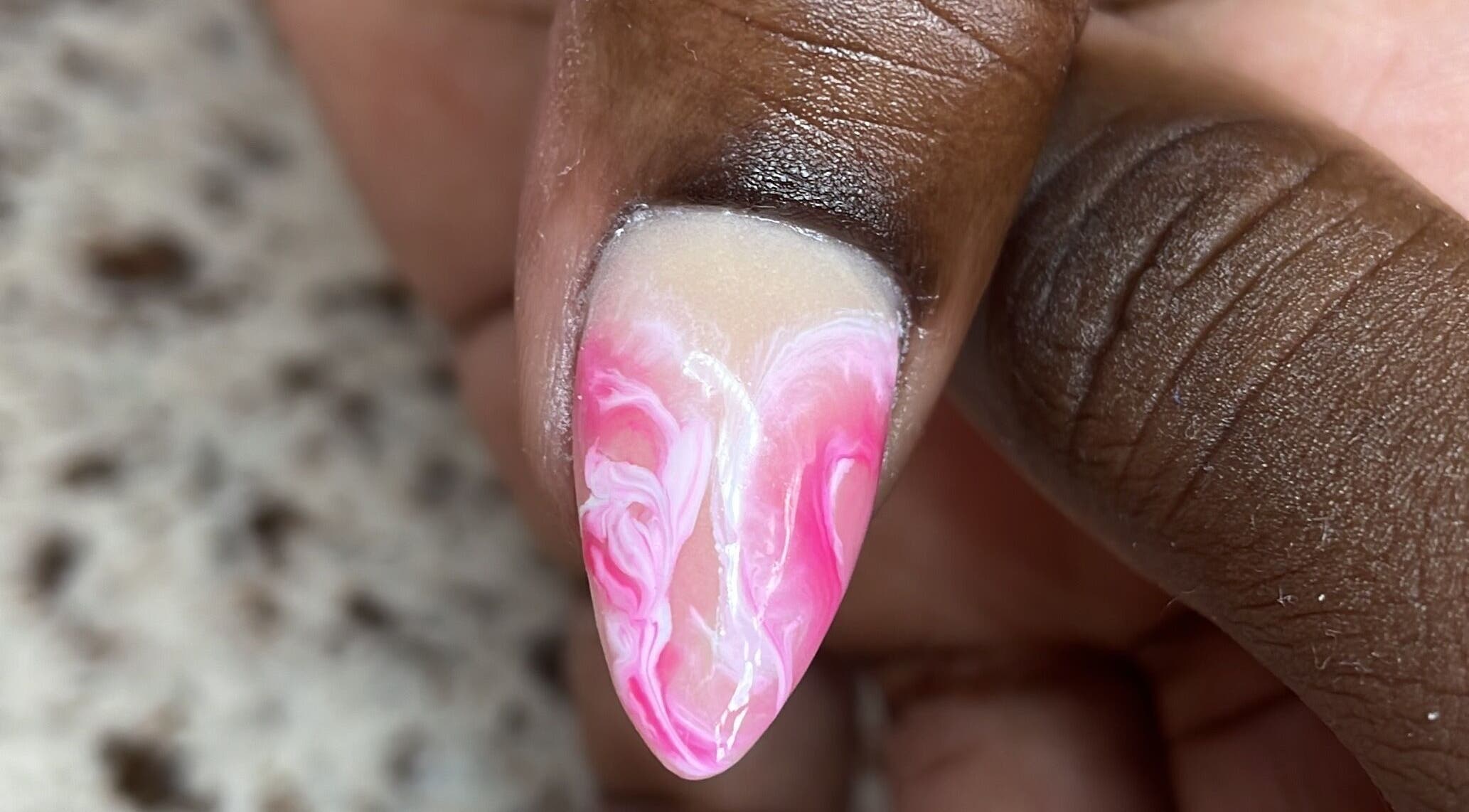 Close-up of a pink and white swirl nail design at Nails On The Blvd, St. James, BB.