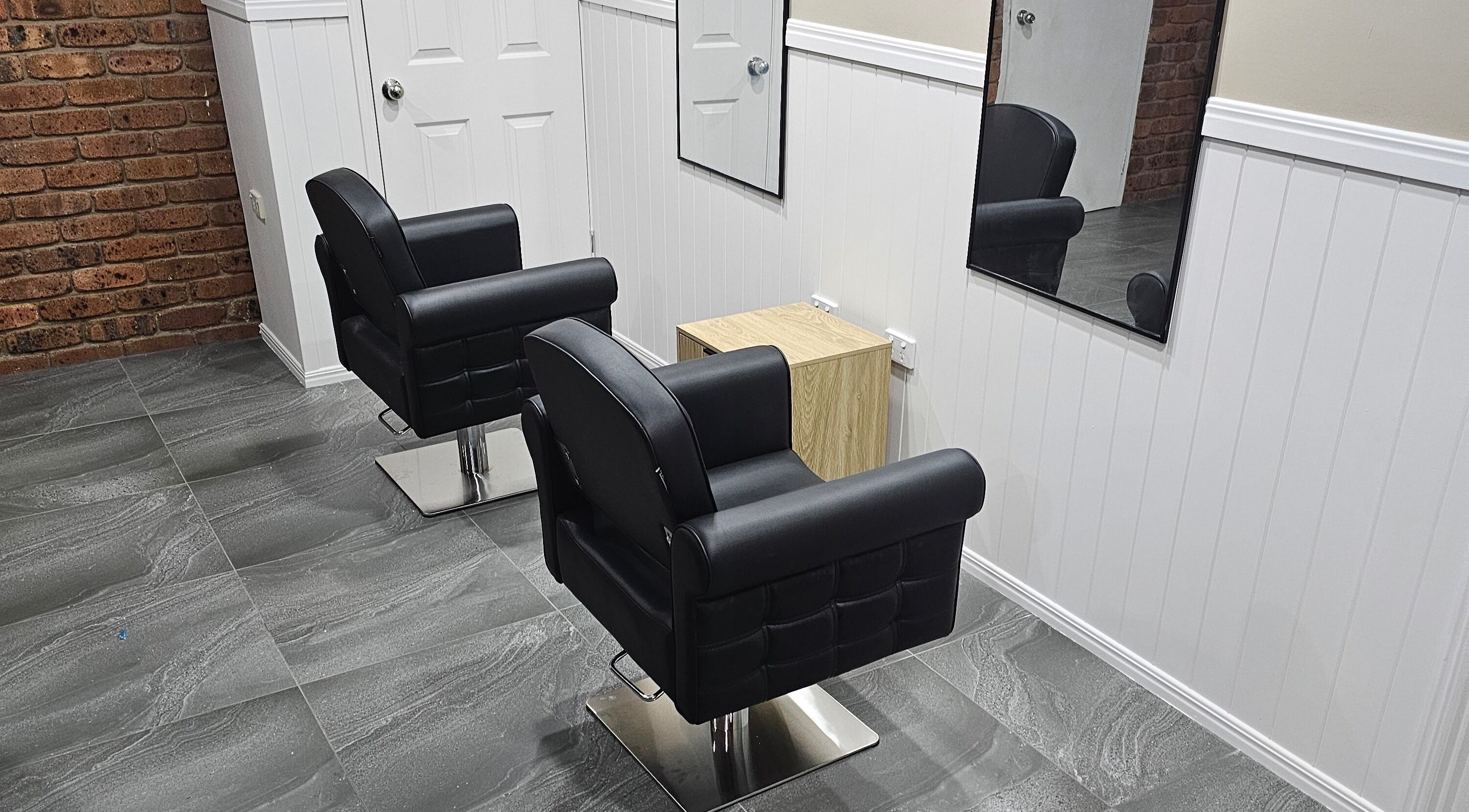 Modern salon chairs at Hair By Nicole in Norman Gardens, Queensland, AU. Sleek and inviting style.