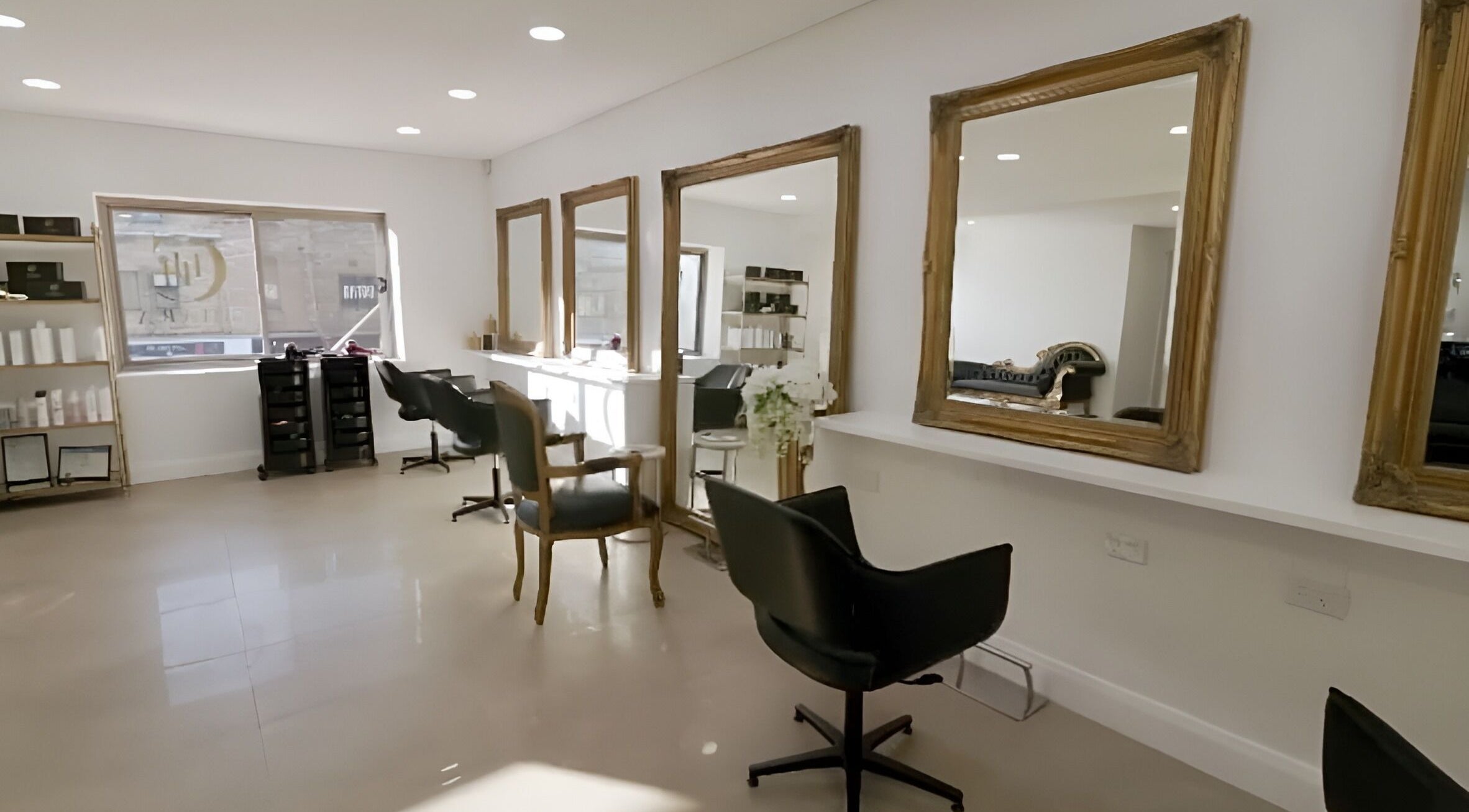 Chic salon interior at Chiara House of Hair, Warrawong, NSW, AU with elegant mirrors and styling chairs.