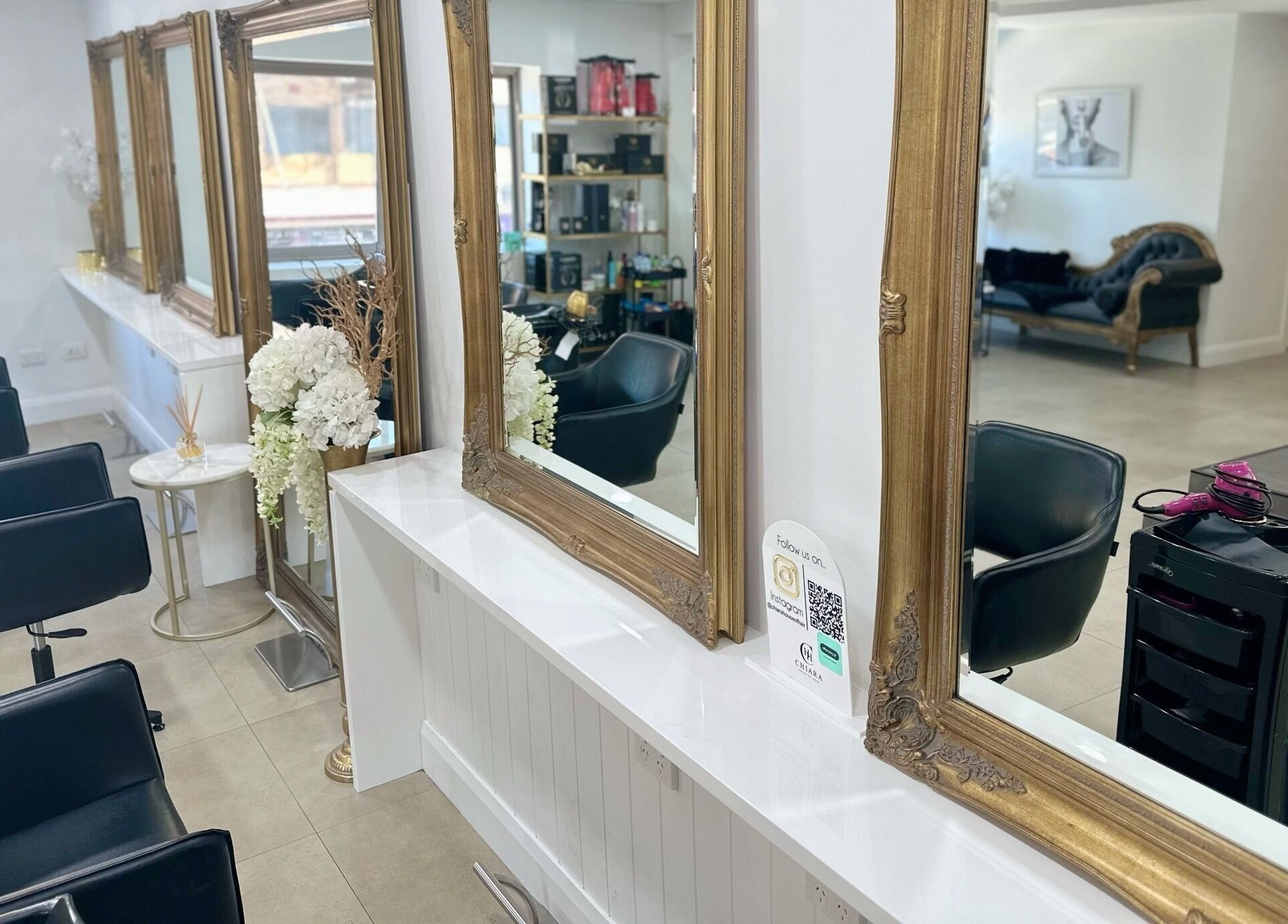 Luxurious salon interior at Chiara House of Hair, Warrawong, NSW, AU featuring ornate mirrors and styling chairs.