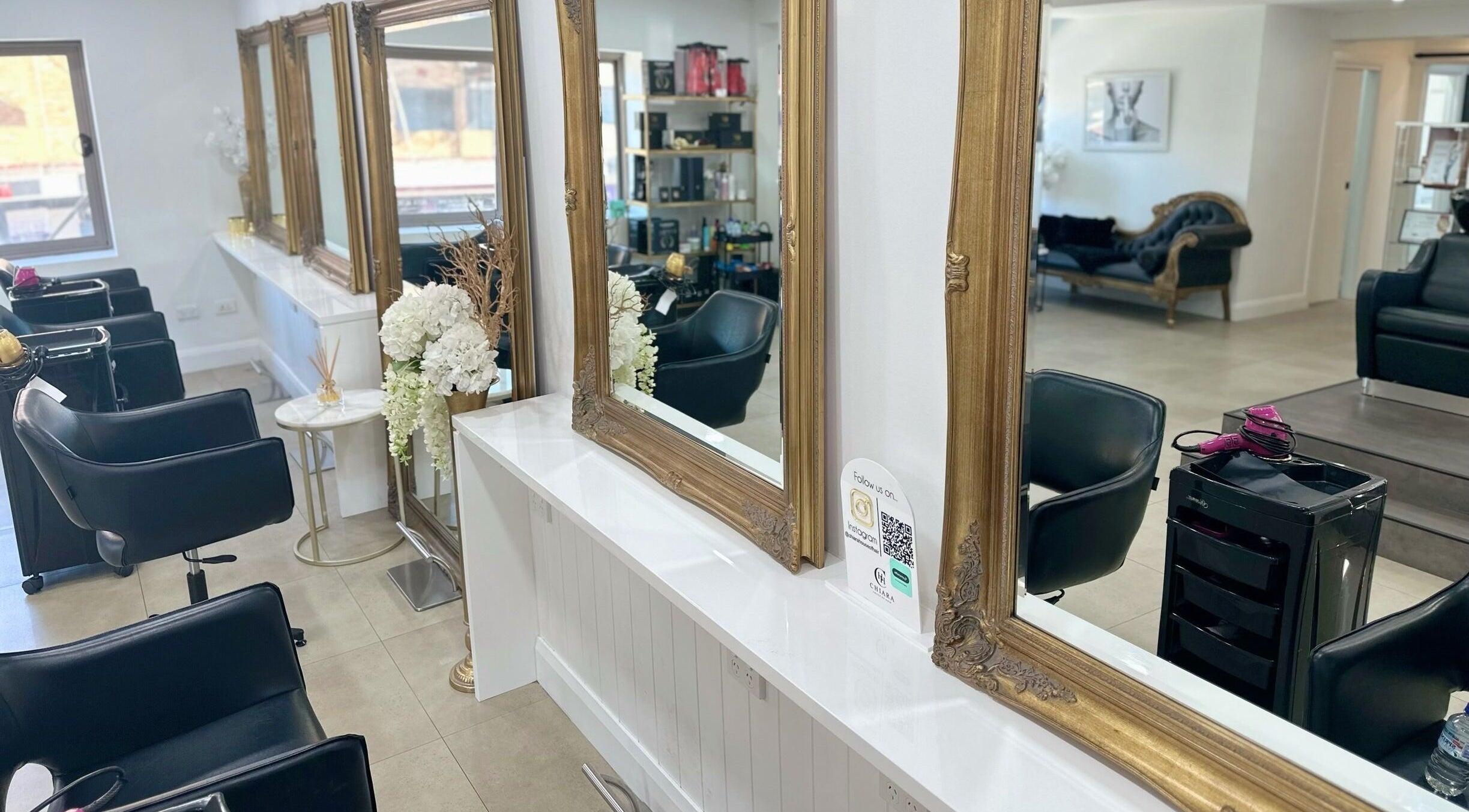 Luxurious salon interior at Chiara House of Hair, Warrawong, NSW, AU featuring ornate mirrors and styling chairs.