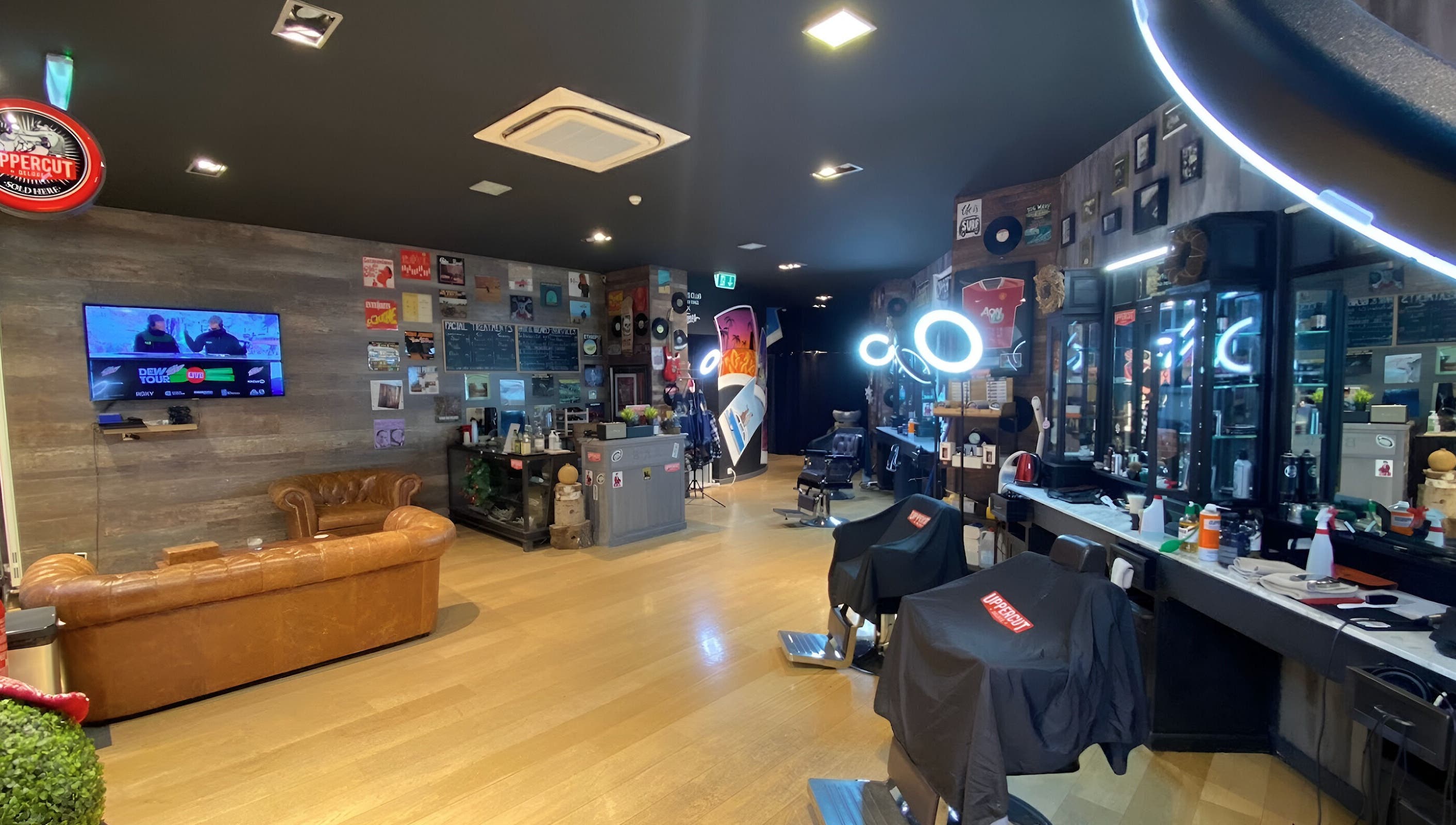 Stylish interior of Men's Club for Good Times in Genève, Genève, CH with leather seating and modern barber chairs.