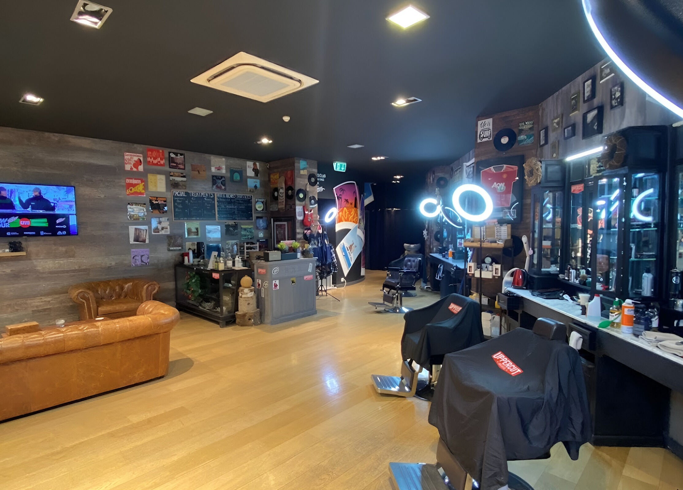 Stylish interior of Men's Club for Good Times in Genève, Genève, CH with leather seating and modern barber chairs.