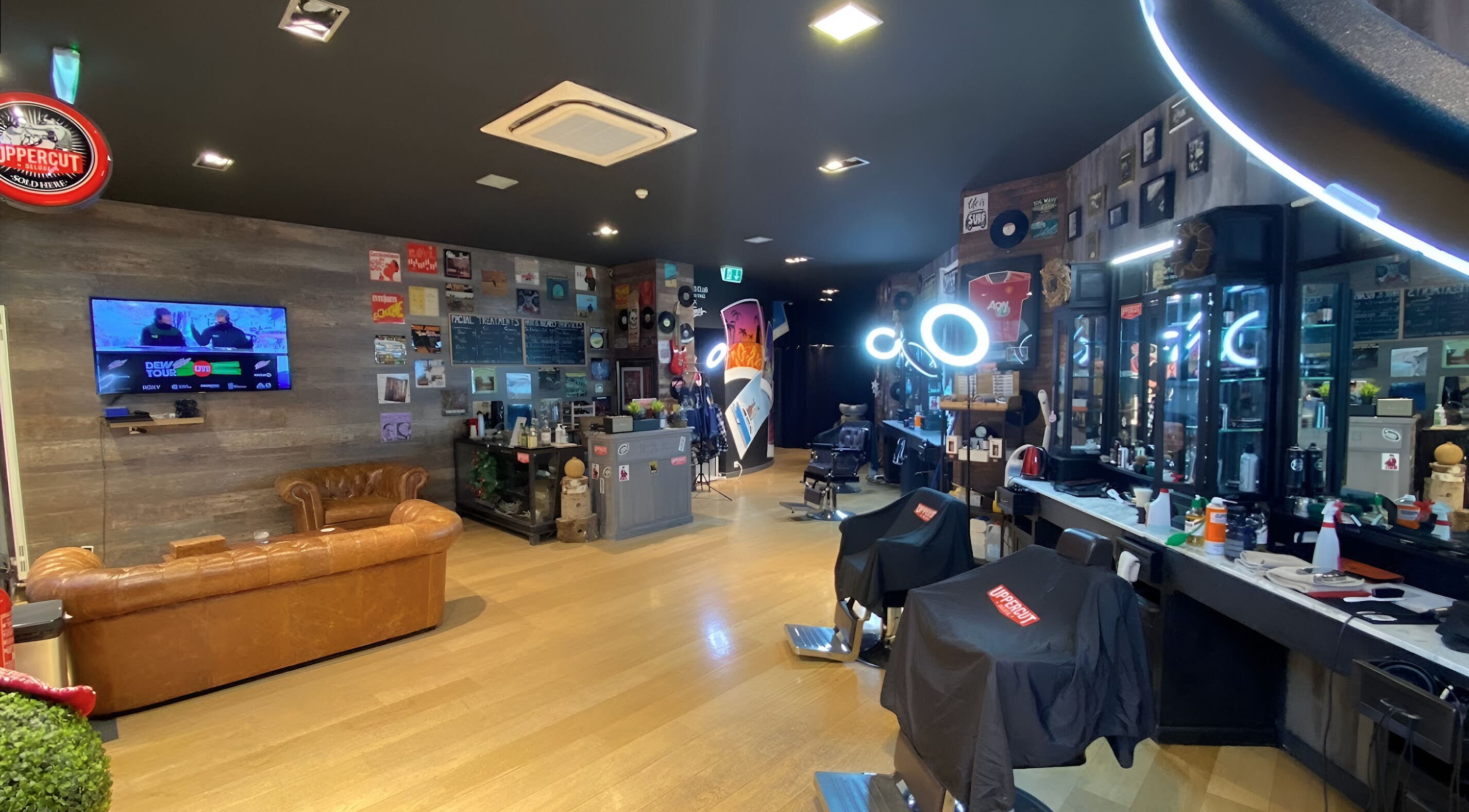 Stylish interior of Men's Club for Good Times in Genève, Genève, CH with leather seating and modern barber chairs.