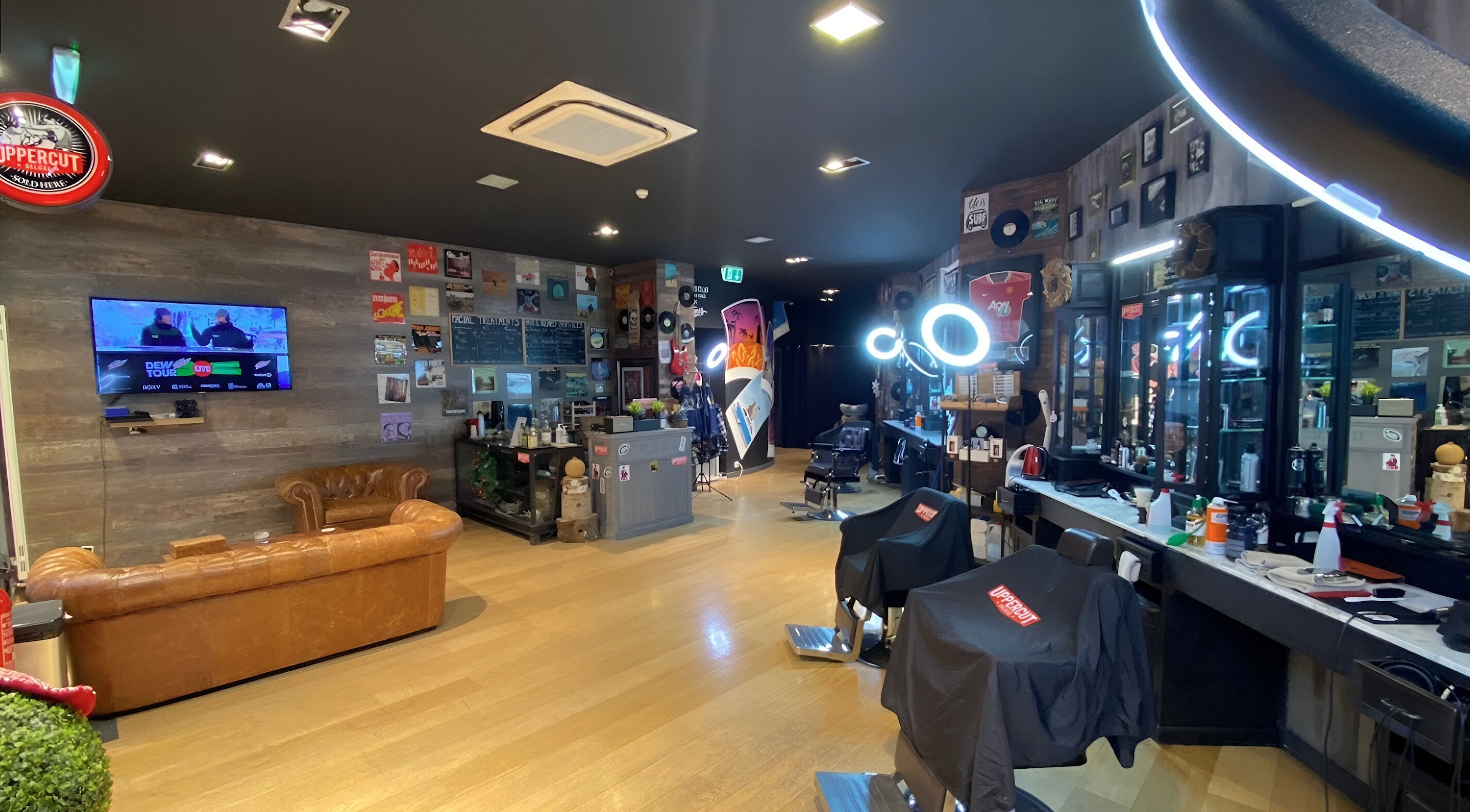 Stylish interior of Men's Club for Good Times in Genève, Genève, CH with leather seating and modern barber chairs.