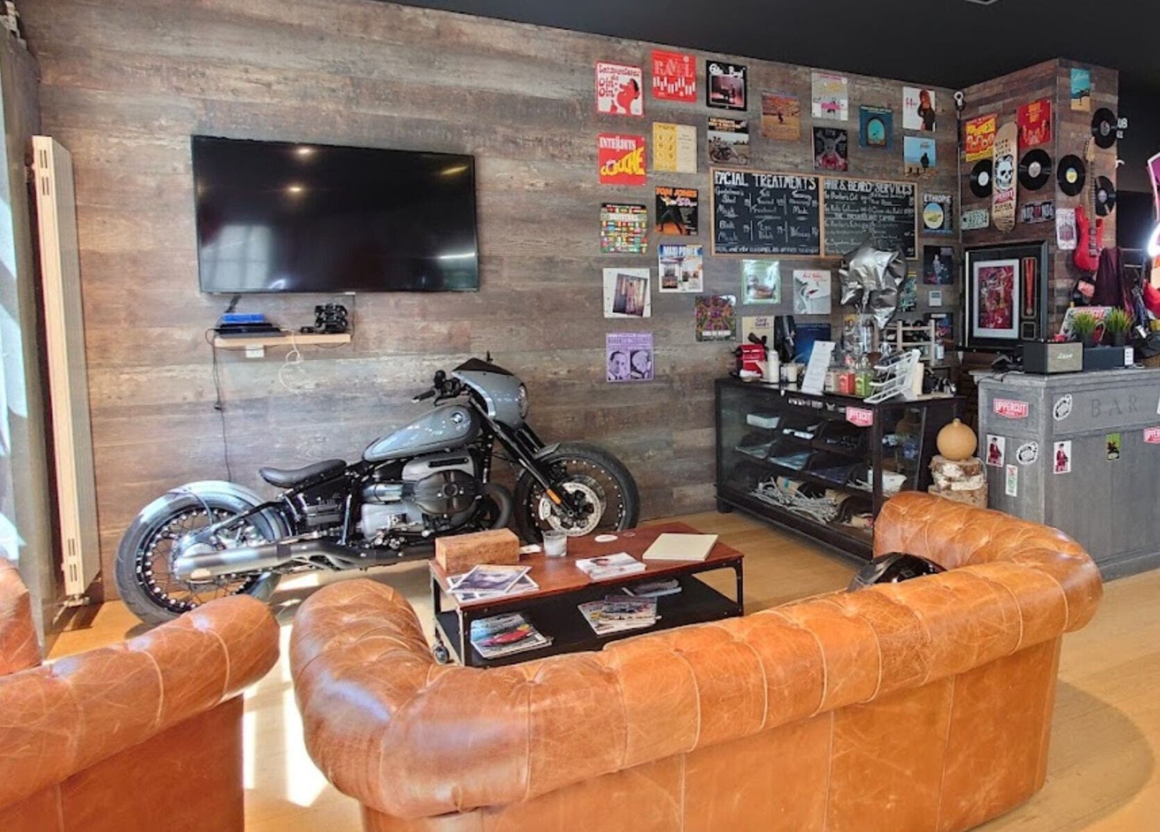 Chic lounge at Men's Club for Good Times, Genève. Features vintage decor and motorcycle.