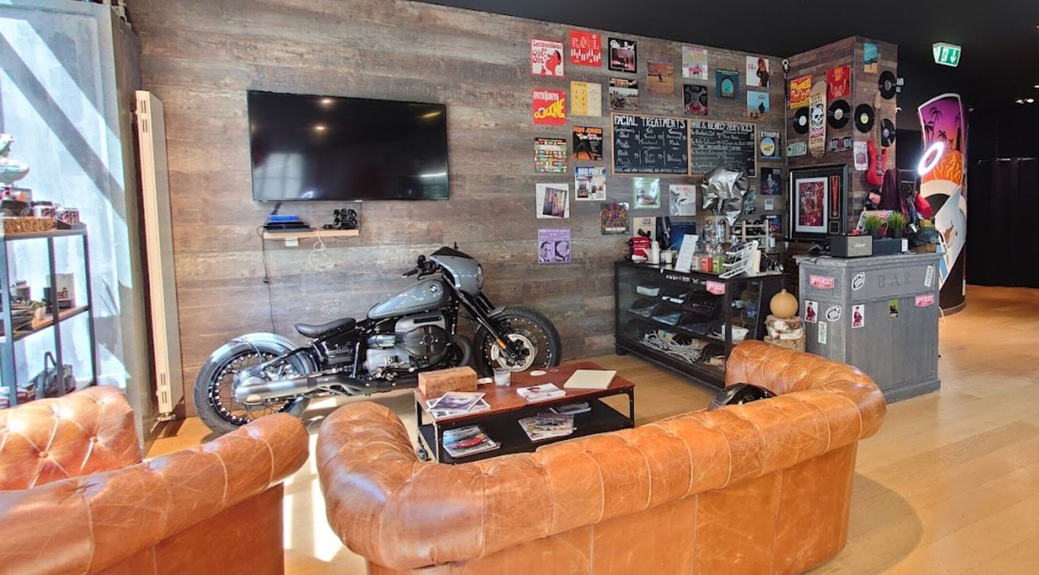 Chic lounge at Men's Club for Good Times, Genève. Features vintage decor and motorcycle.