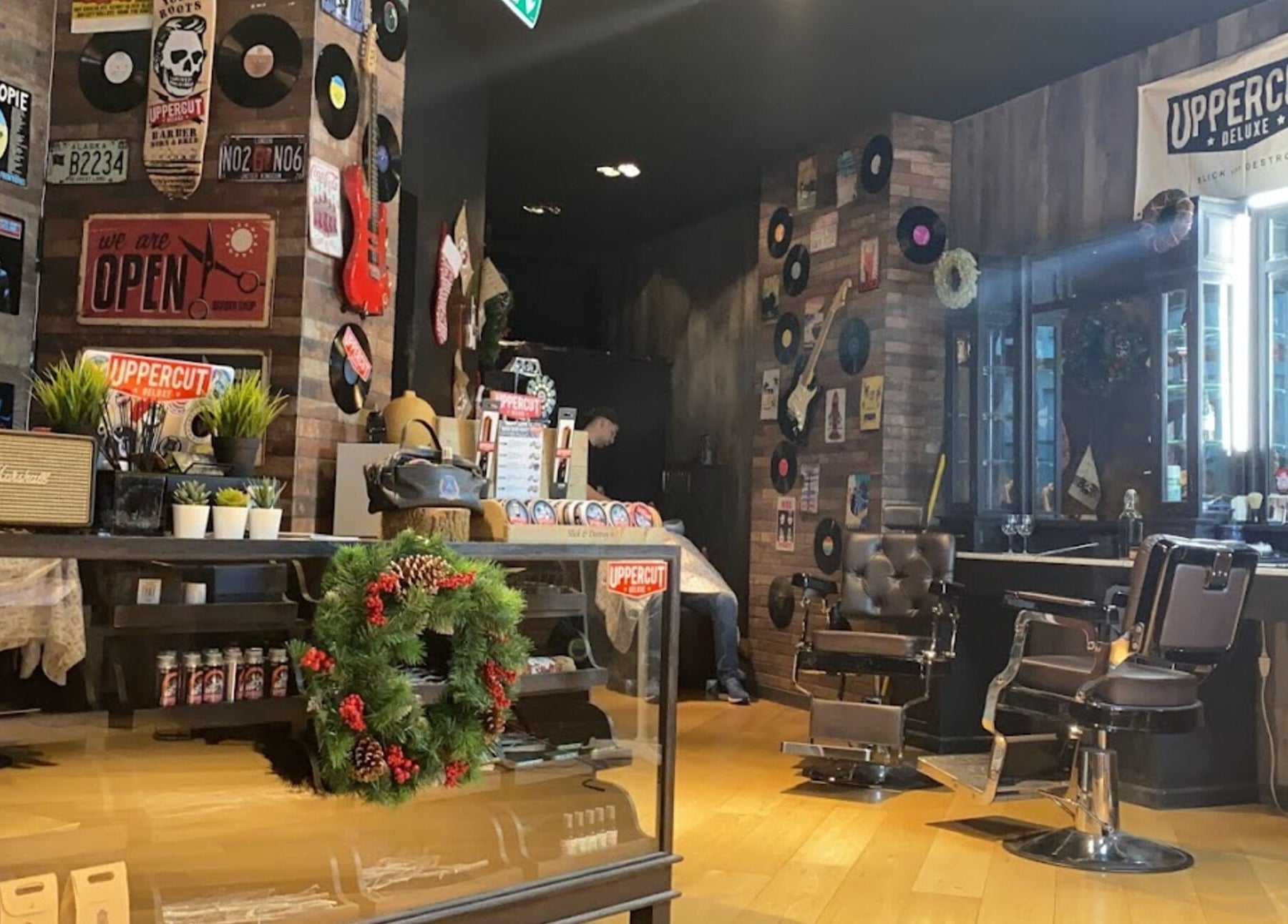 Trendy retro barber interior at Men's Club for Good Times, Genève, Genève, CH with chic decor and vintage elements.