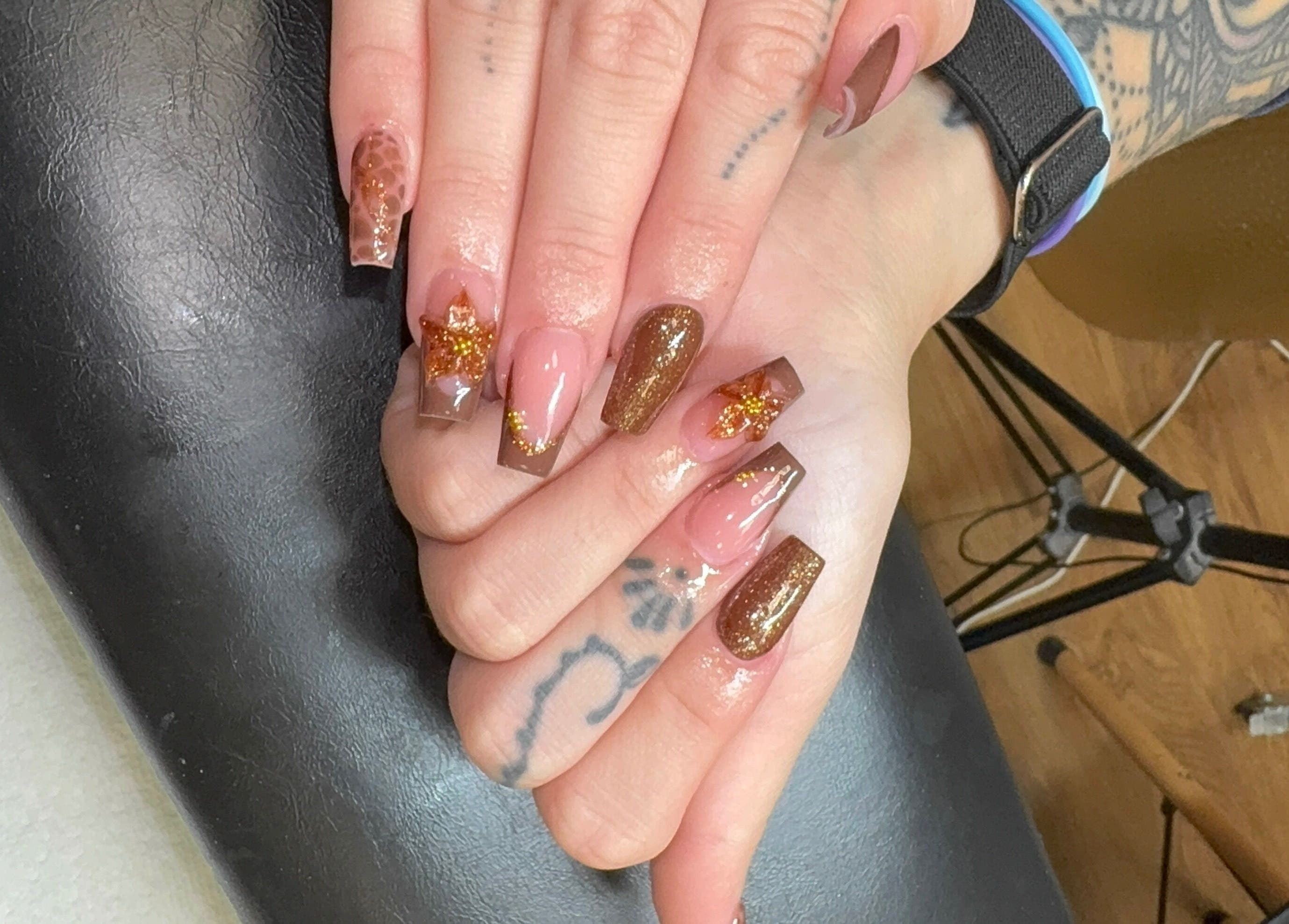 Stylish manicure with glitter at Elegant Esthetics, Debary, Florida, US showcasing intricate nail art.