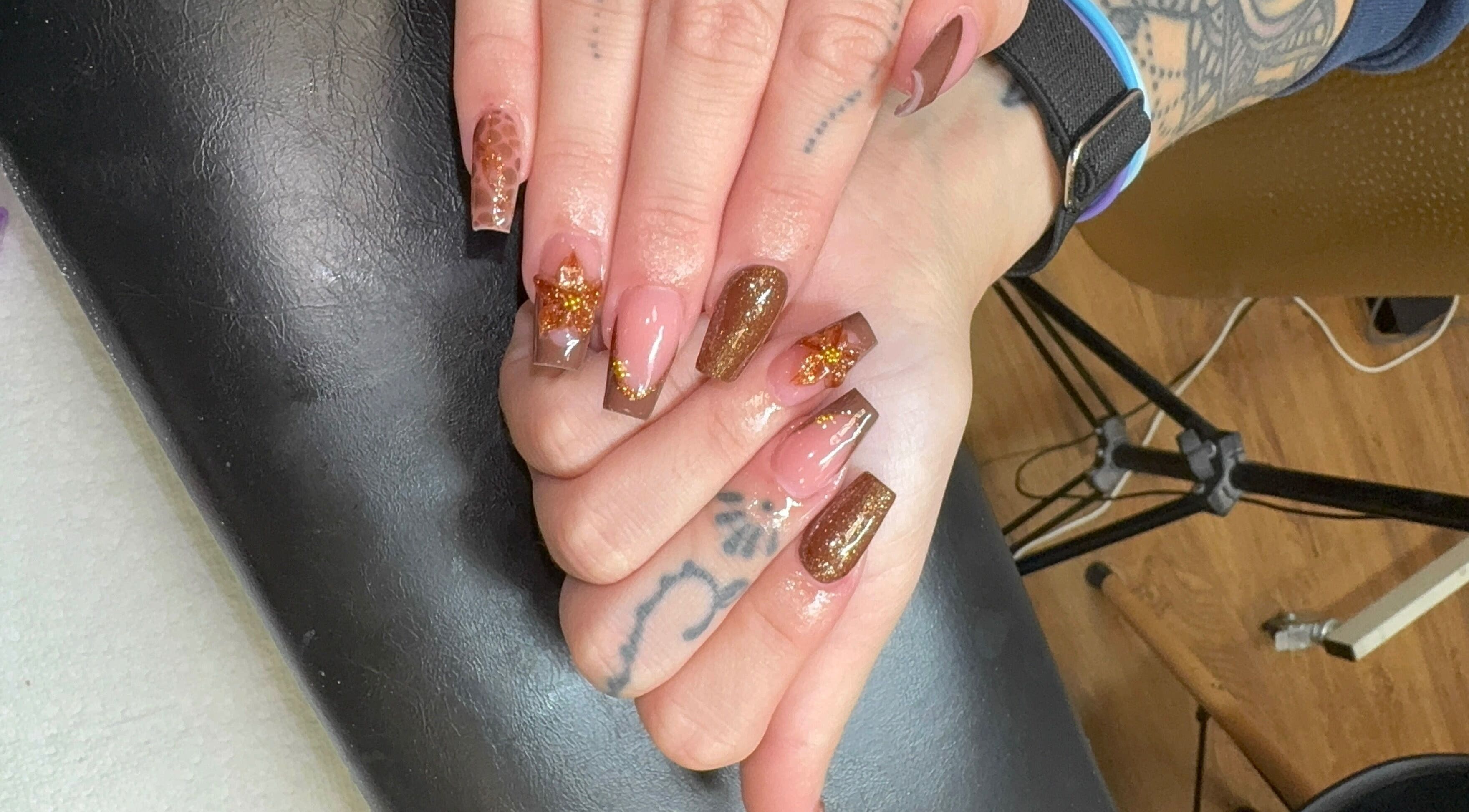 Stylish manicure with glitter at Elegant Esthetics, Debary, Florida, US showcasing intricate nail art.