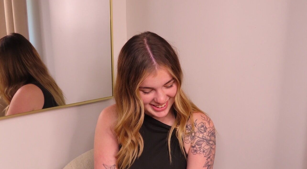 Smiling woman with floral tattoo at Fuzion Hair & Beauty, North Yunderup, Western Australia, AU.