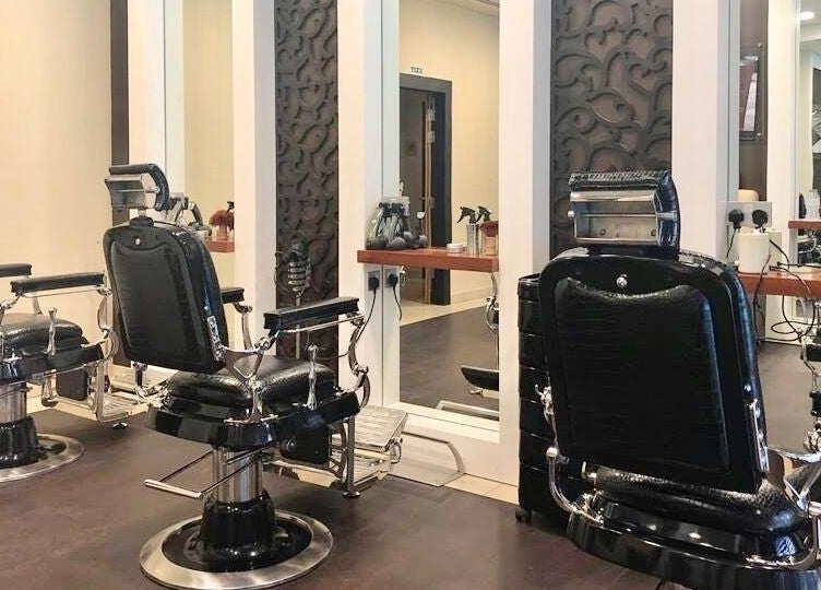 Elegant barber chairs at Zaki Gents Salon - Anantara, Dubai, Dubai, AE with stylish interior design.