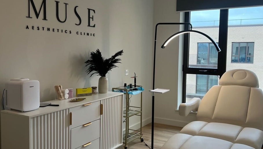 Luxurious treatment room at Muse Aesthetics, Greenford, England, GB with a plush chair and modern decor.