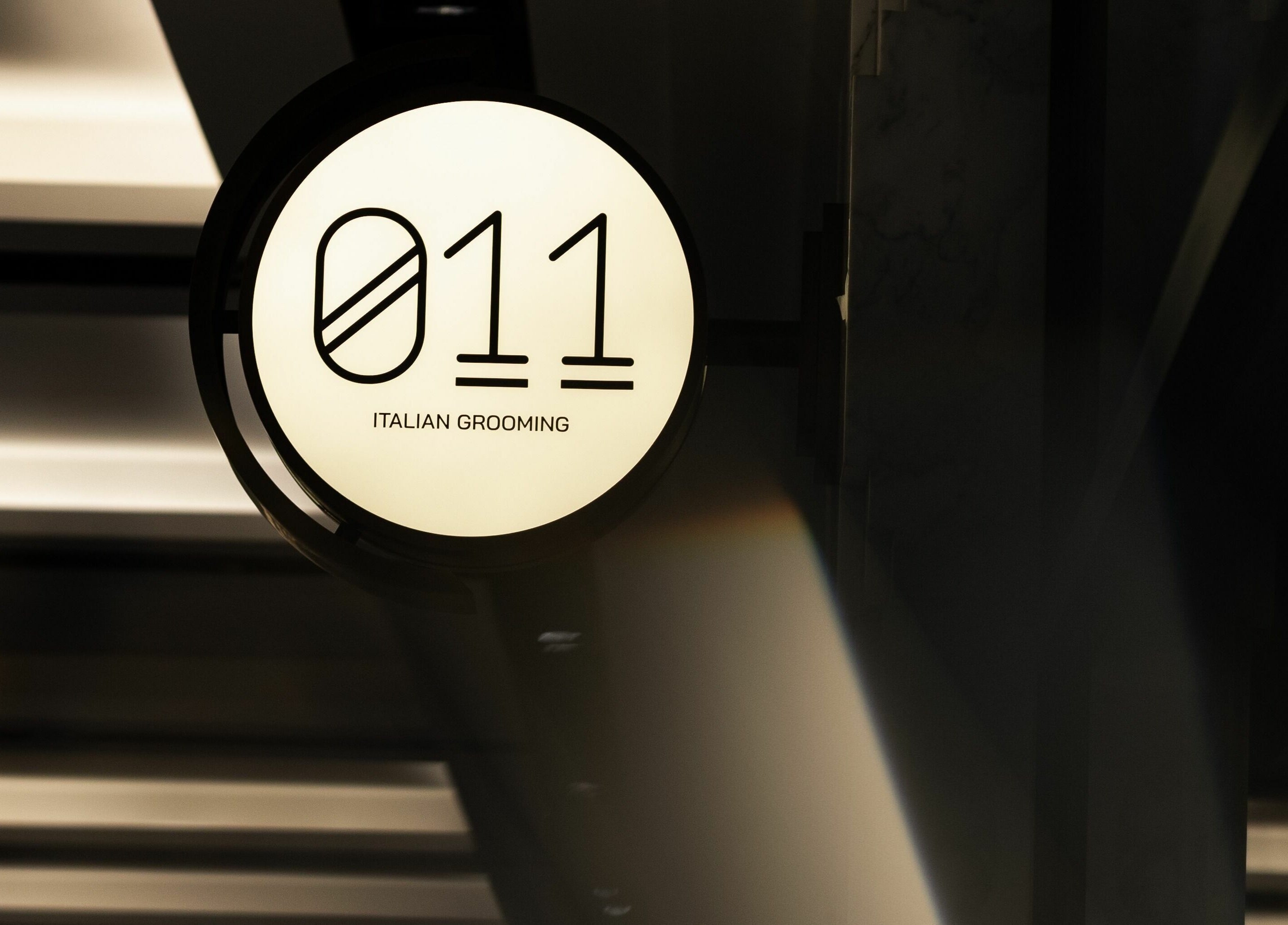 Illuminated sign of 011 Italian Grooming DIFC, Dubai, Dubai, AE, showcasing its distinct branding.