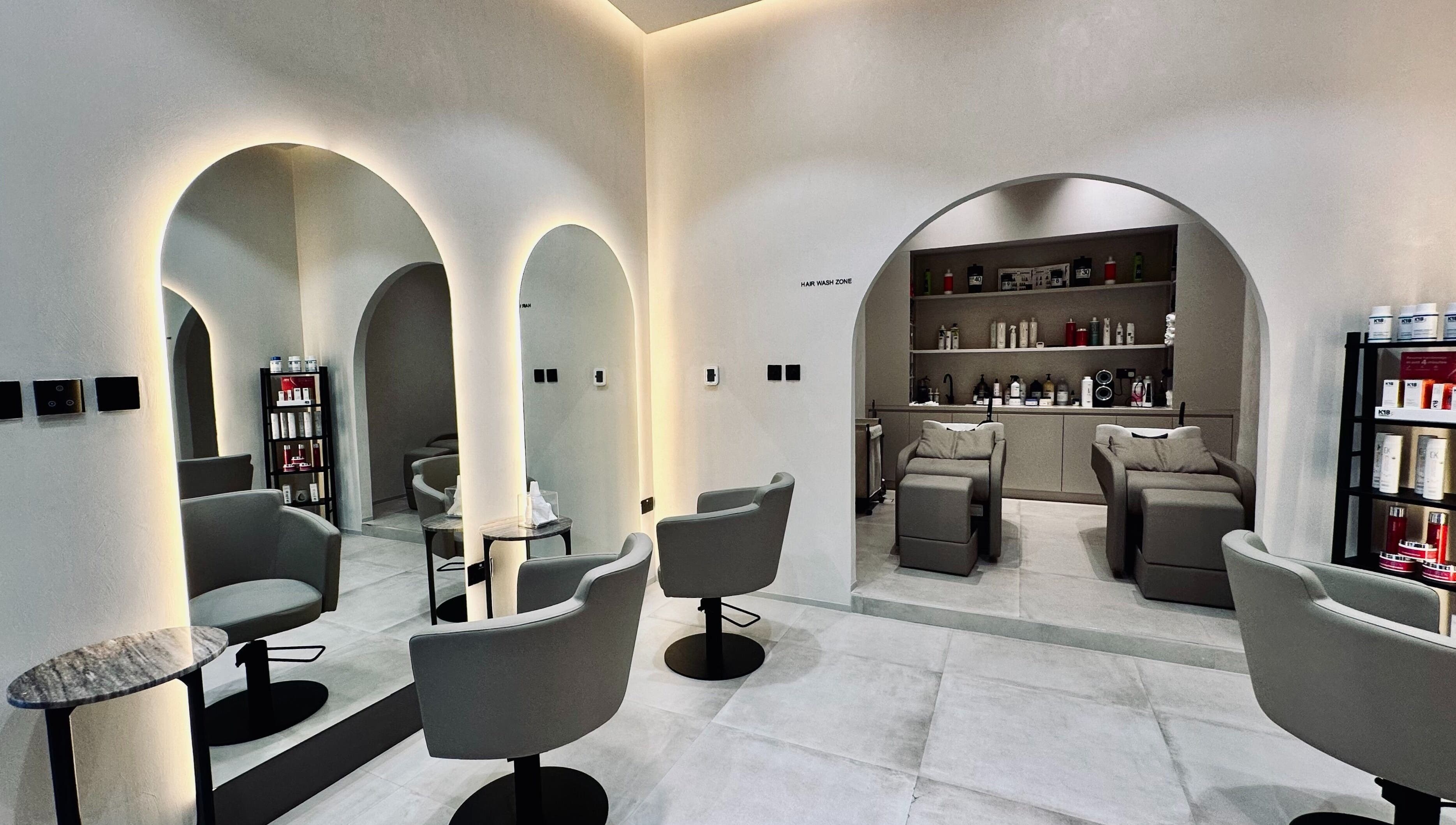 Sophisticated salon interior at Olea Wellness Beauty Salon, Dubai, Dubai, AE. Modern chairs, mirrors, and products.