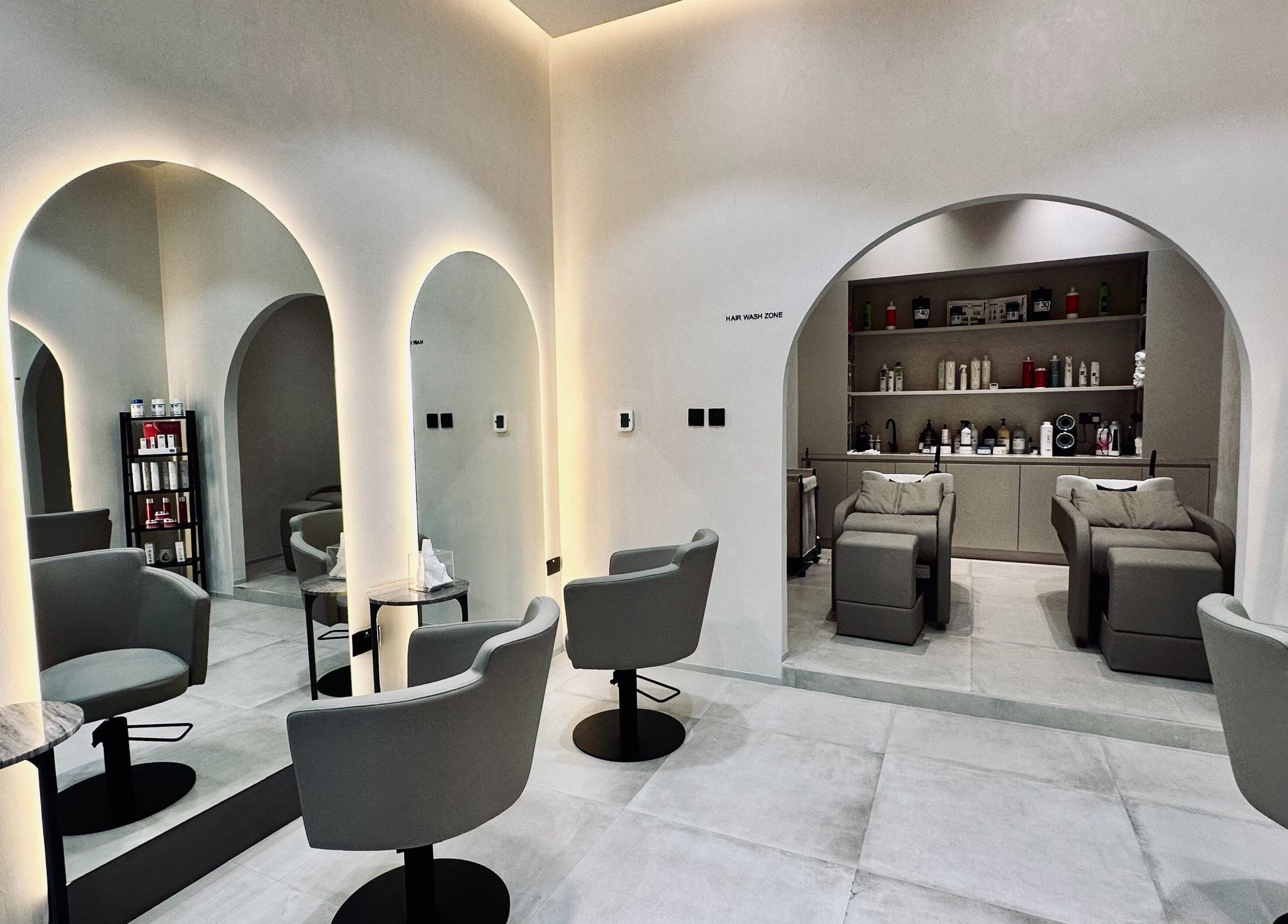 Sophisticated salon interior at Olea Wellness Beauty Salon, Dubai, Dubai, AE. Modern chairs, mirrors, and products.