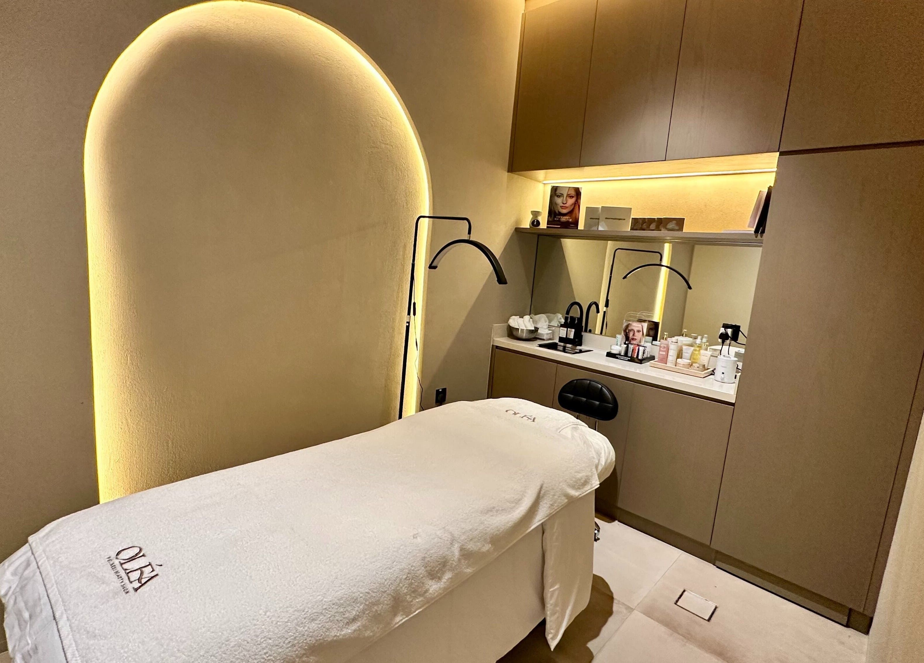 Relaxing treatment room at Olea Wellness Beauty Salon, Dubai, Dubai, AE with ambient lighting and cozy bed.