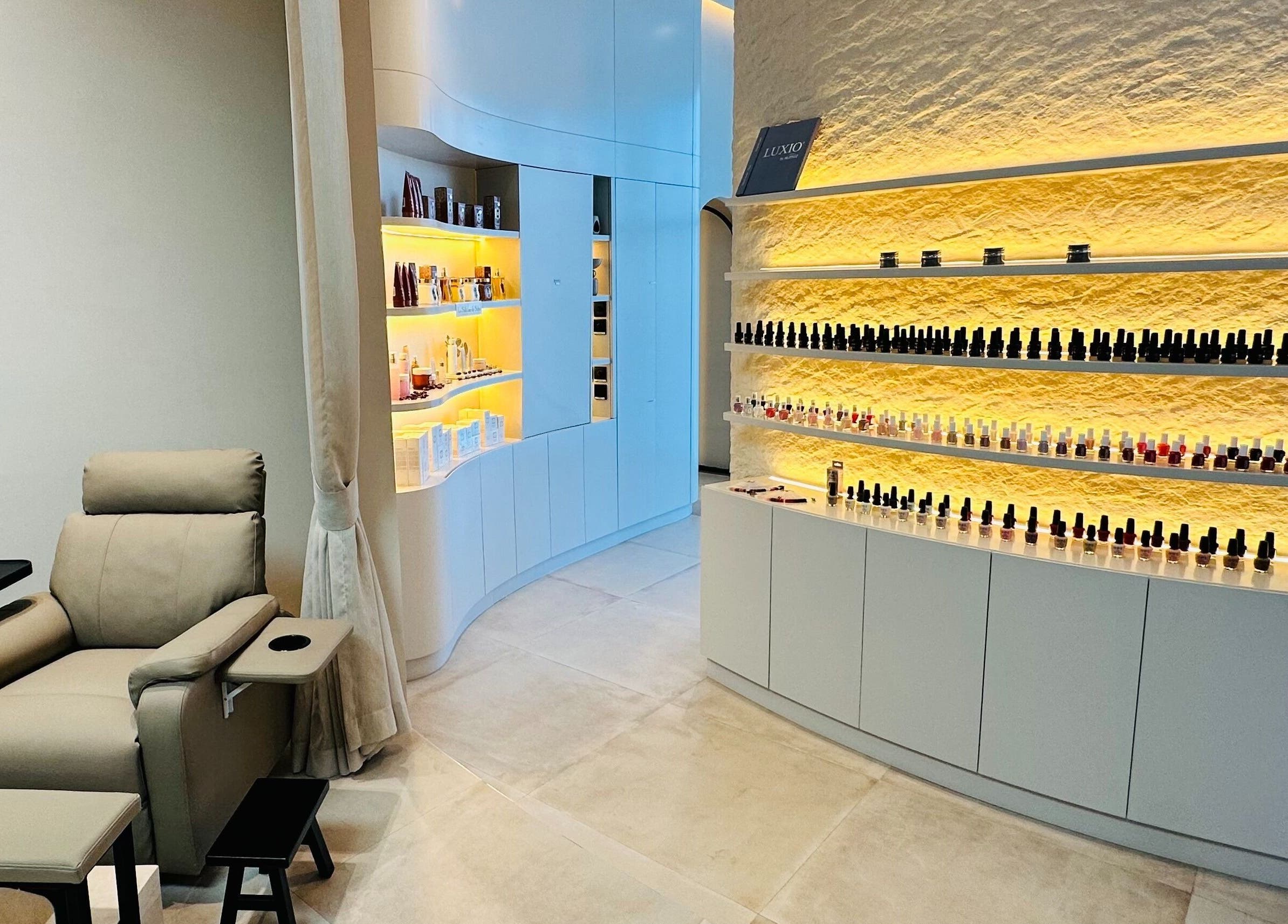 Relaxing nail care area at Olea Wellness Beauty Salon, Dubai, Dubai, AE, featuring elegant seating and product display.