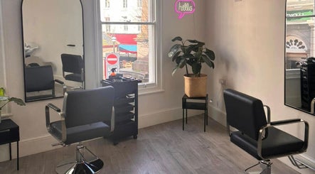 Modern salon seating in Vibe Hairdressing, Saint Helier, St Helier, JE, featuring stylish décor and mirrors.