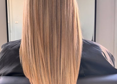 Smooth, straight blonde hair styled at Vibe Hairdressing in Saint Helier, St Helier, JE.
