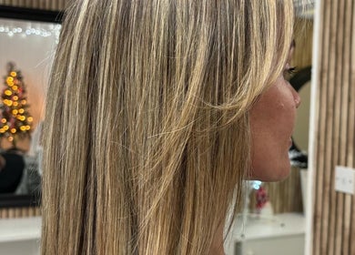 Blonde hair styled at Vibe Hairdressing salon in Saint Helier, St Helier, JE with festive decor reflection.