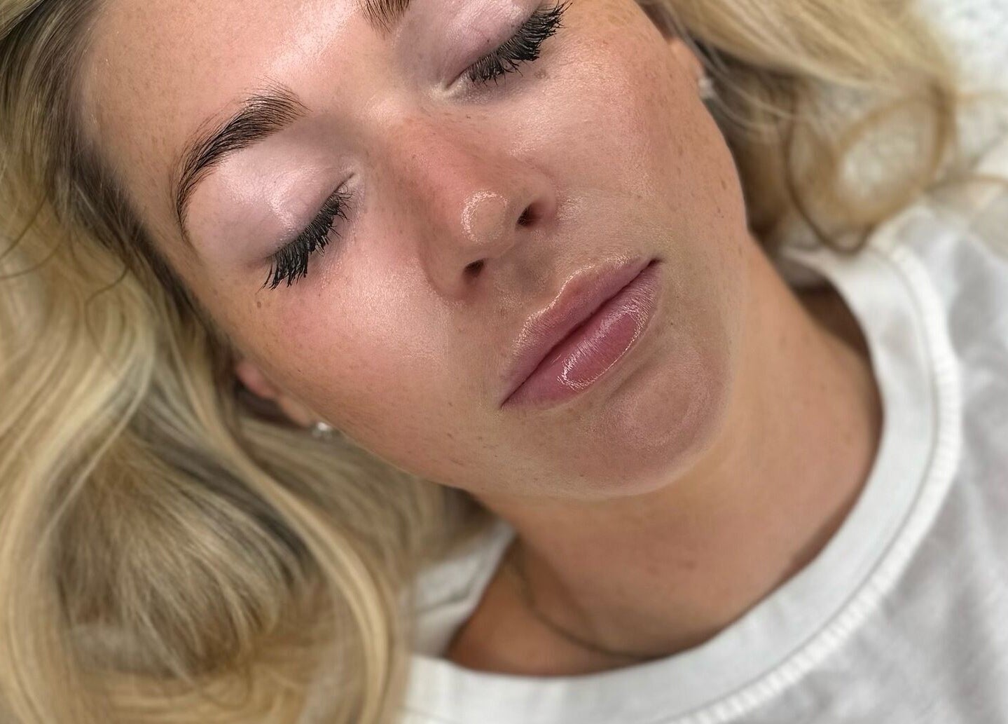 Relaxed woman enjoying facial treatment at Nu Glow by Teri, Worsley, England, GB.