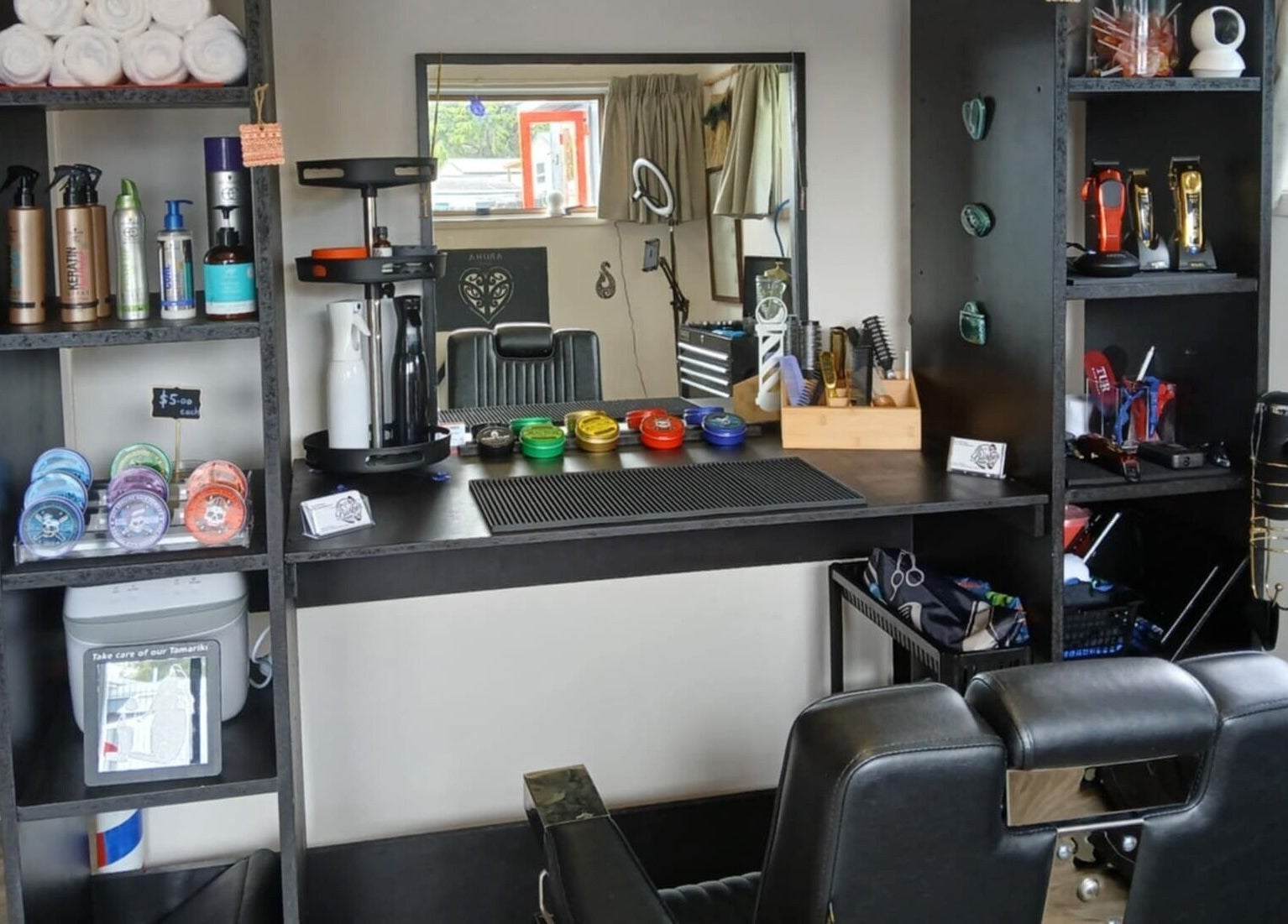 Chic grooming station at BBI Barbers, Whangārei, Northland, NZ, featuring hair products and tools.