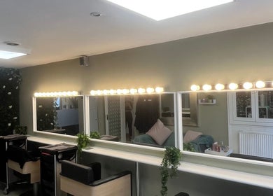 ErinLeylandHair salon in Accrington, England with illuminated mirrors and seating stations.